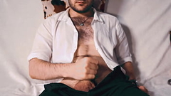 Handsome Noel Dero watches porn and caresses his dick in a condom close-up. Thumb