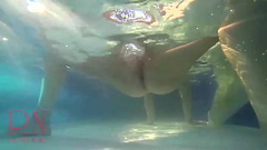 Elegant and flexible babe, swimming underwater in the outdoor swimming pool. 2 Thumb