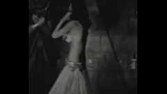 A slender brunette in an exotic costume dances excitedly on the stage of an abandoned theater Thumb