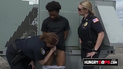 Black criminal is apprehended by two big titty MILFs. Thumb